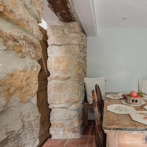 Admire striking original elements like the masonry and timber beams