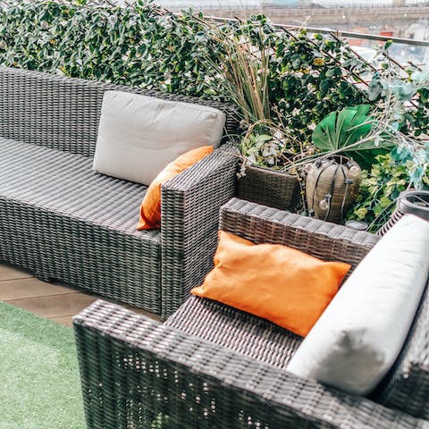 Relax outdoors on the plant-filled private balcony
