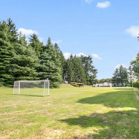 Gather the group for a game of football on the lawn