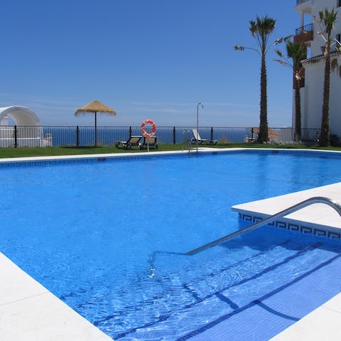 Swim some laps in the communal pool downstairs and sun yourself on the poolside loungers with a sea view