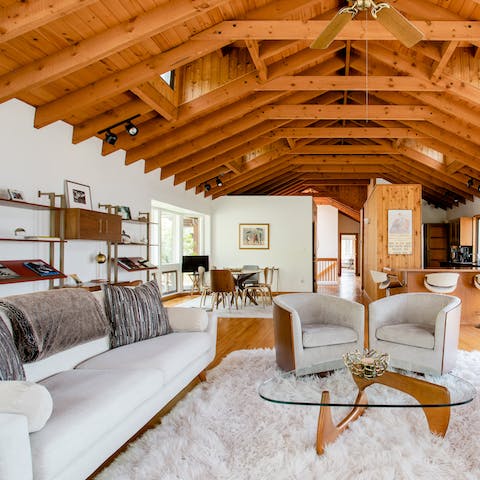 Find a comfy spot in the elegant living space with a glass of wine