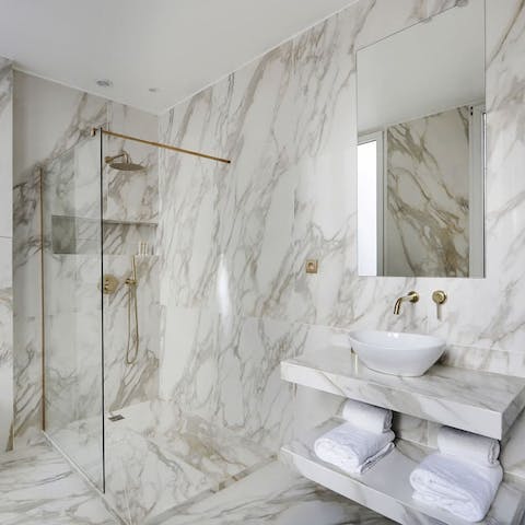 Start your mornings with a luxurious soak under the marble bathrooms' rainfall showers