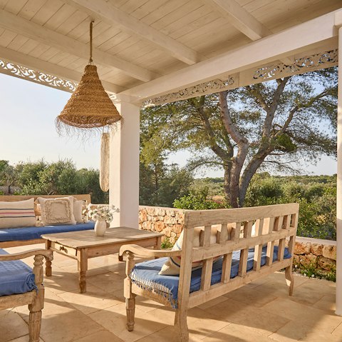 Sip drinks with a peaceful olive grove backdrop