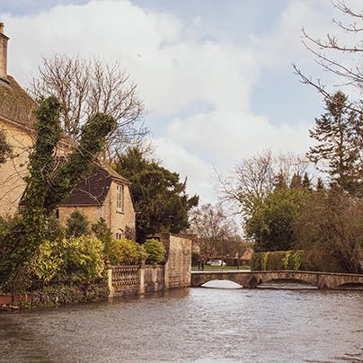 Soak up the beauty of Bourton-on-the-Water as you stroll along the river