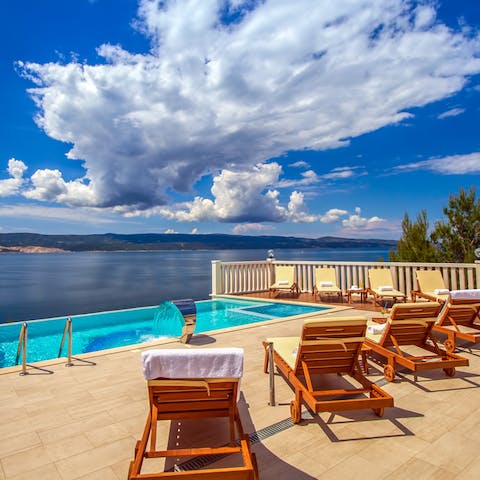 Spend dreamy days lounging by the infinity pool, taking swims to the edge for undisturbed views of the sea