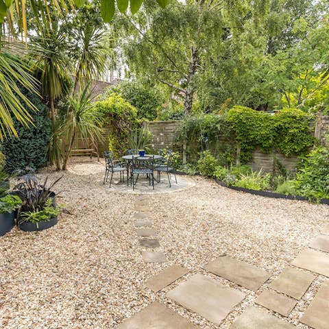 Relax in the lush, private garden with its palms