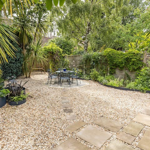 Relax in the lush, private garden with its palms