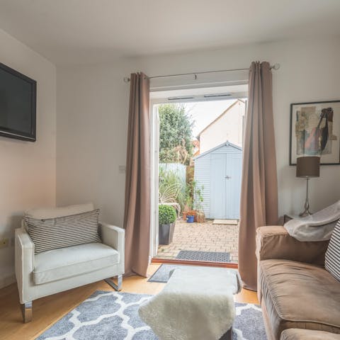 Throw open the French doors as you cosy up in the living room