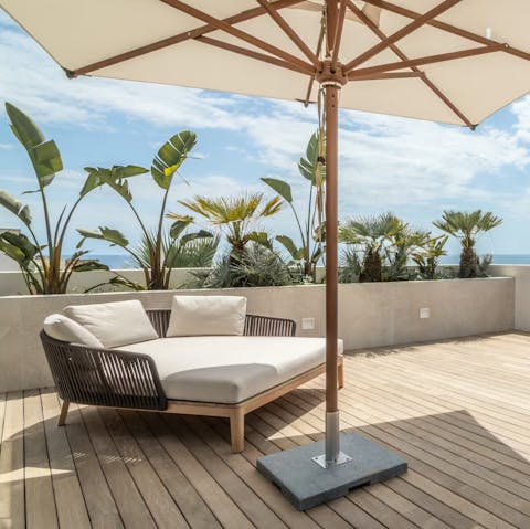 Find some shade on the terrace to relax with your holiday read