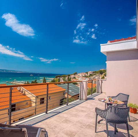 Step out onto the balcony to soak in the sun and sea views with a drink
