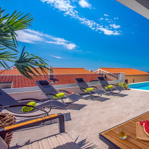 Catch some sun and work on that perfect holiday tan on the sun loungers