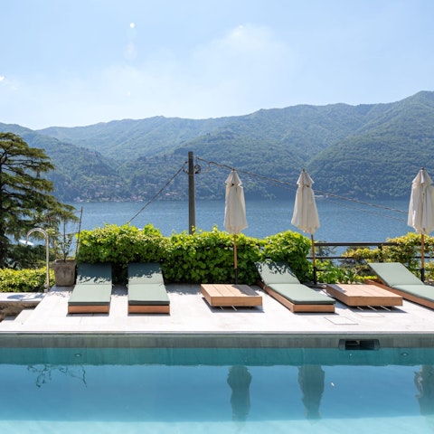 Swim in the private pool with mountain and lake views