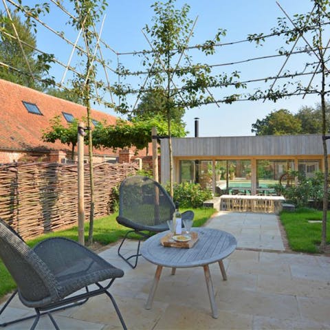 Unwind in the lush gardens with a glass of wine