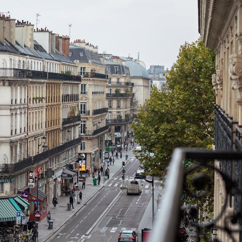 Perch by the living room's Juliet balcony with a glass of French wine and indulge in some people-watching