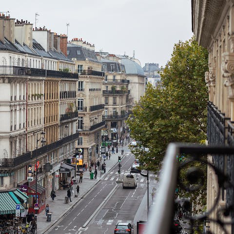 Perch by the living room's Juliet balcony with a glass of French wine and indulge in some people-watching