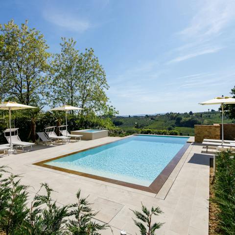 Relax by the pool on a lounger or bob about in the water
