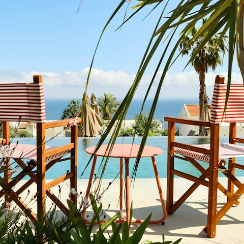 Enjoy poolside sea views at this property