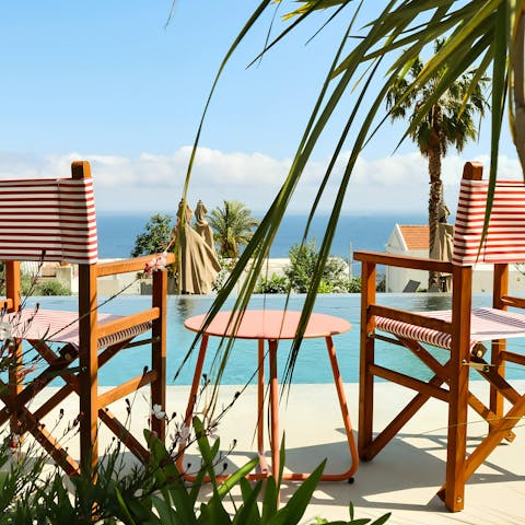 Enjoy poolside sea views at this property