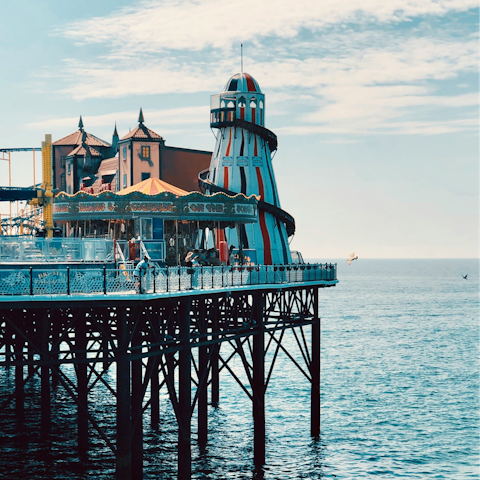 Discover thrilling rides and delicious food stands on Brighton Palace Pier