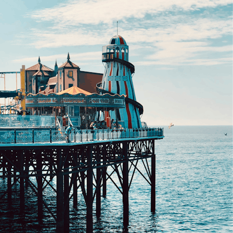 Discover thrilling rides and delicious food stands on Brighton Palace Pier