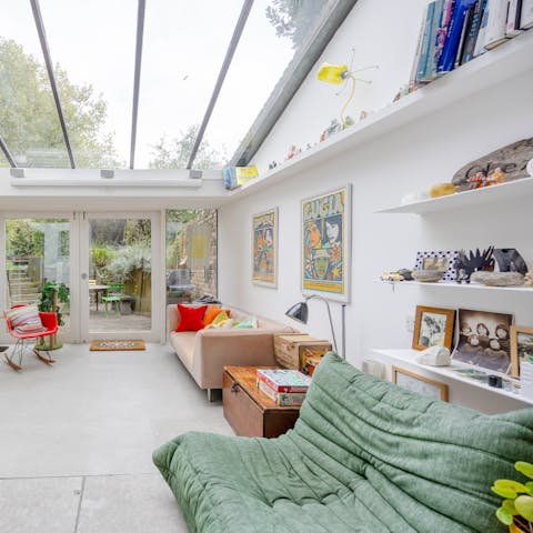 Enjoy a good book in the light and airy glass annex