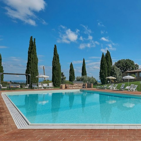 Soak up the sun with a glass of wine next to the pool
