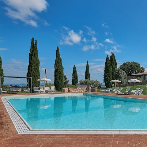 Soak up the sun with a glass of wine next to the pool