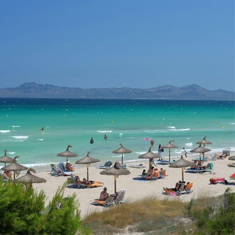 Spend the day at Platja de Muro, a ten-minute drive away