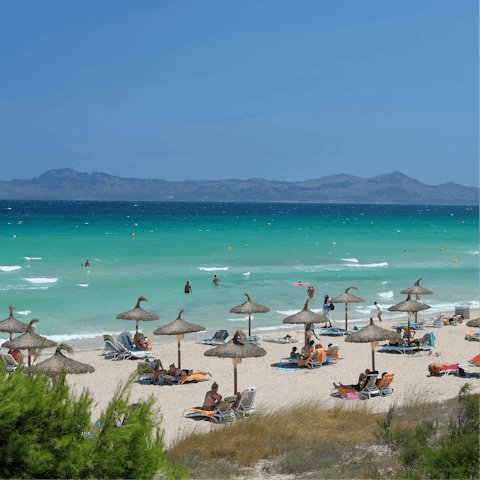 Spend the day at Platja de Muro, a ten-minute drive away