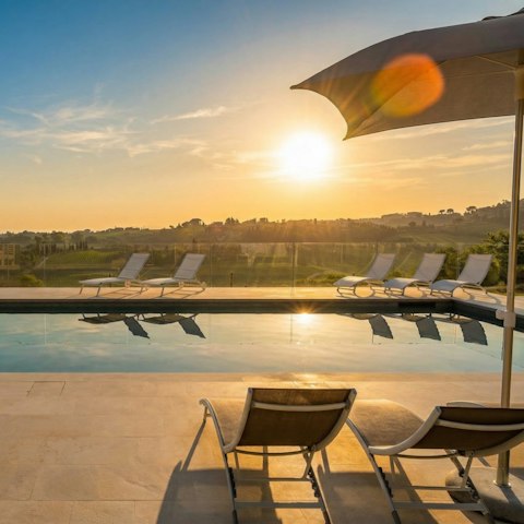 Stretch out poolside as the Tuscan hills glow at sunset