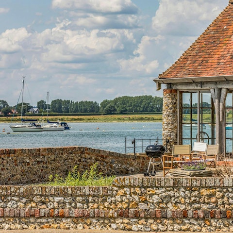 Fire up the barbecue and watch the boats glide by from the garden