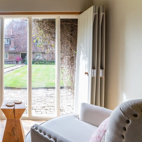 Sip a cup of tea in the comfy armchair as you look out across the manicured garden