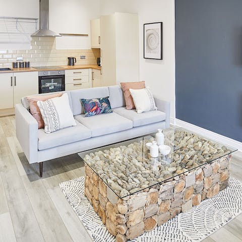 Enjoy a glass of wine in the open plan living space with its beach theme