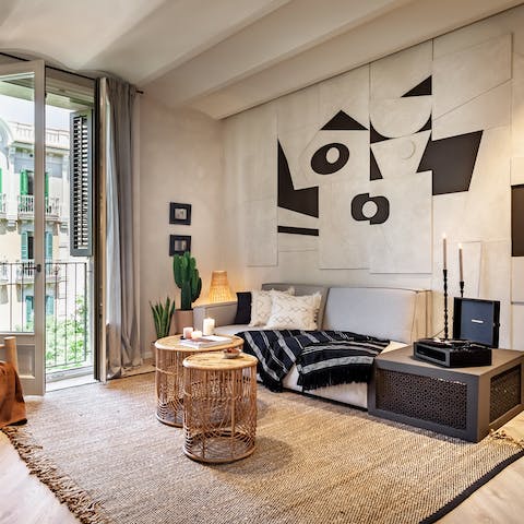 Perch by the living room's Juliet balcony with an evening glass of wine while the record player serenades you