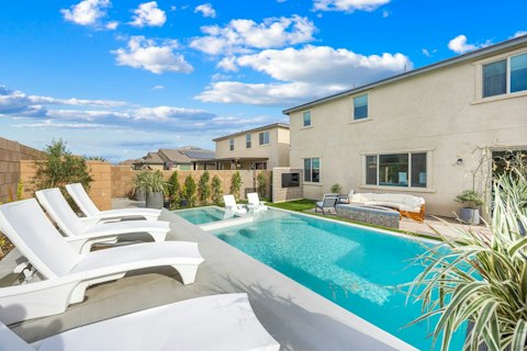 Stretch out on sun loungers beside the sparkling pool