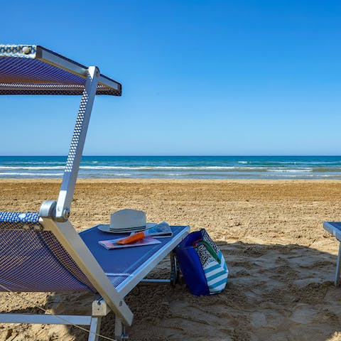 Stroll across the road to sink your feet into the sand at Santa Maria del Focallo beach