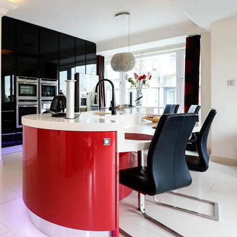 Share a meal and a bottle of wine around the sleek red dining bar