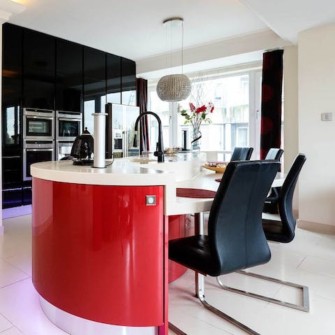 Share a meal and a bottle of wine around the sleek red dining bar