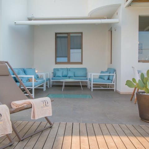 Sip sundowners in the paved relaxation area with comfy seating