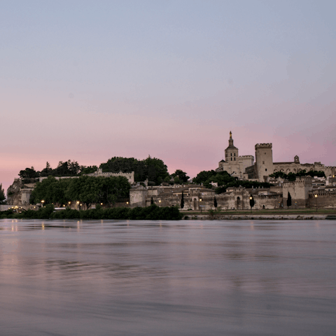 Explore Avignon, a 30-minute drive away