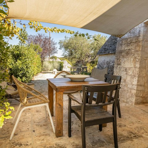 Enjoy a pasta feast at the shaded alfresco dining table