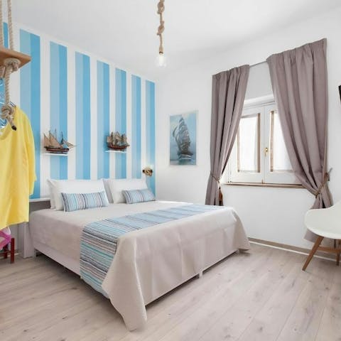Relax in the coastal-inspired bedroom after a busy day exploring
