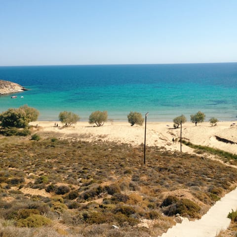 Get a sun-kissed glow on the golden sands of Kalogeros Beach, just a thirteen minute drive away