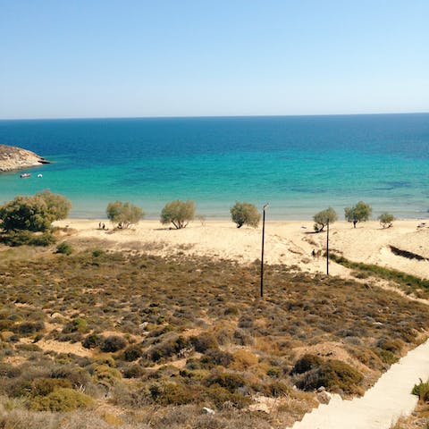 Get a sun-kissed glow on the golden sands of Kalogeros Beach, just a thirteen minute drive away
