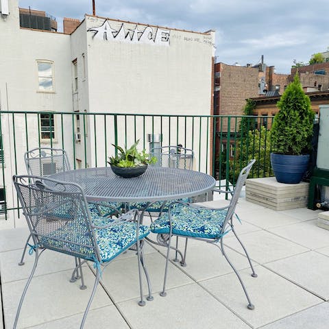 Sit around the table on the rooftop terrace with a long island iced tea