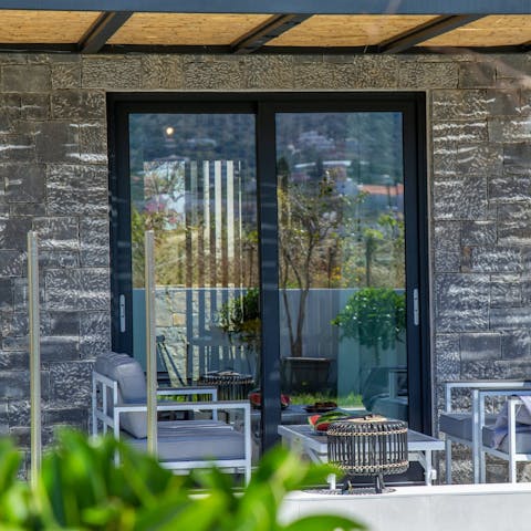 Relax on the covered terrace with a good book for company