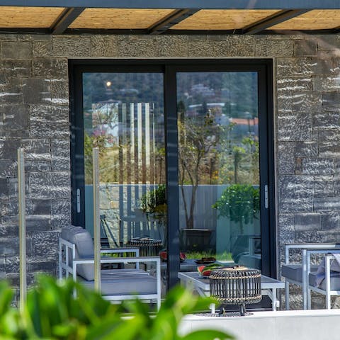 Relax on the covered terrace with a good book for company