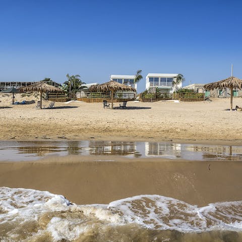 Walk out of the apartment and onto the beautiful beach