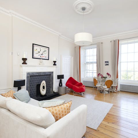 Kick your feet up in a modern living space, lit by large windows