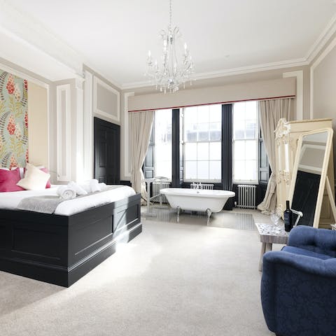 Wake up in a romantic bedroom, boasting a freestanding bathtub